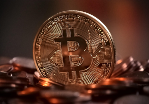 Gold bitcoin coin with the ₿ symbol representing cryptocurrency and digital money