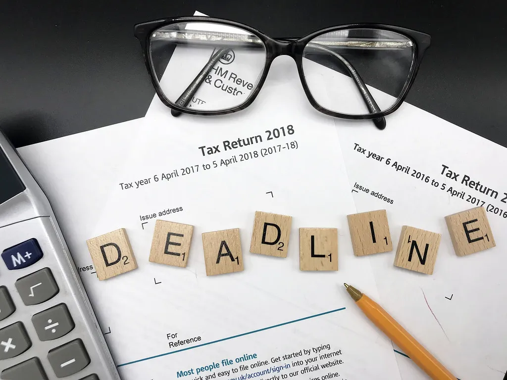 SARS provisional tax notice 202701 - tax return deadline forms, glasses and calculator